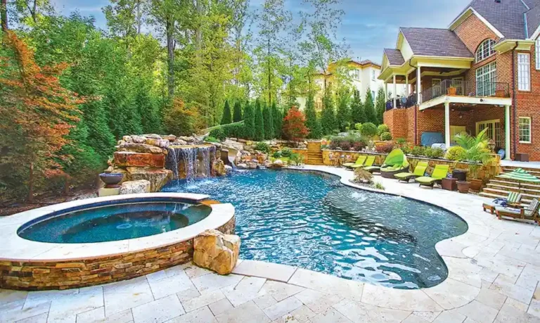 Grand estate luxury pool with rock grotto, water slide, and spa patio