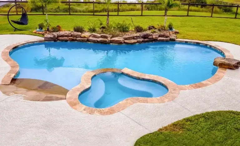 Lagoon pool with integrated spa and rock waterfall with scenic view