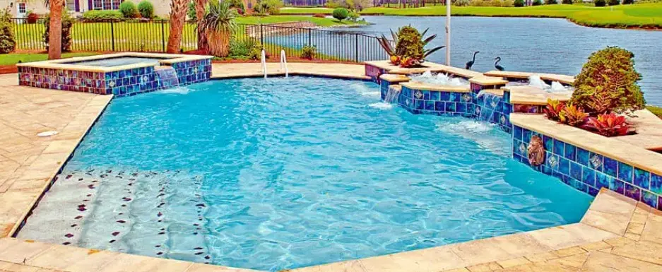 Lakefront pool with cobalt mosaic tile spa and multi-tier fountain