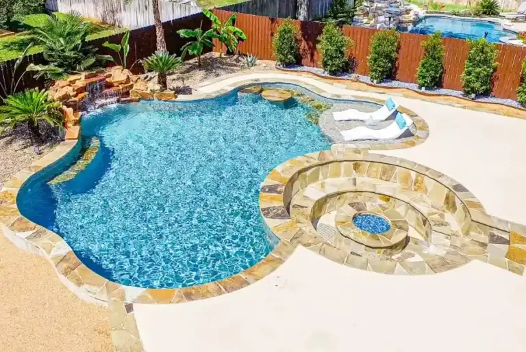 Luxury pool with sunken fire pit lounge, swim-up table, and waterfall