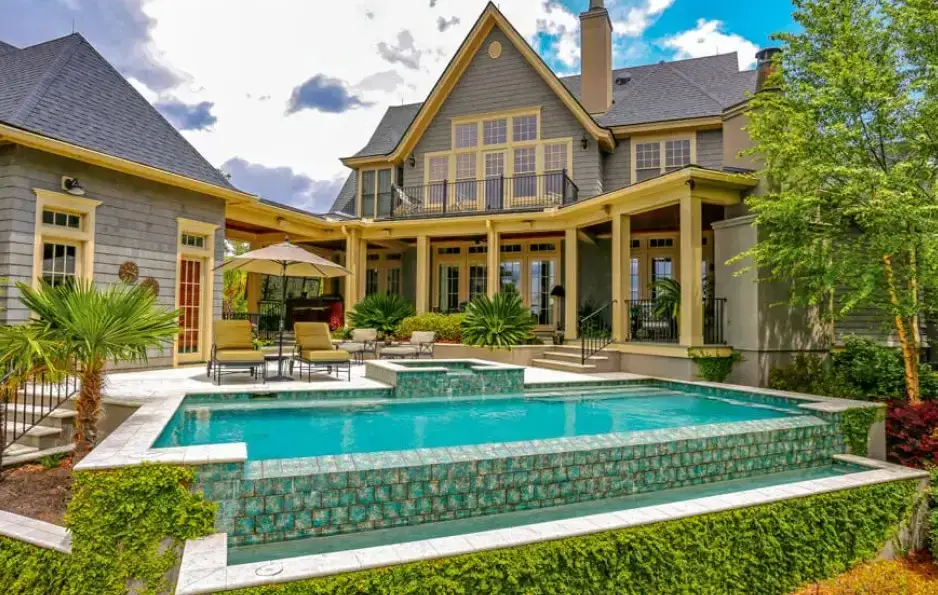 Luxury tiered pool with raised spa and turquoise tile overflow