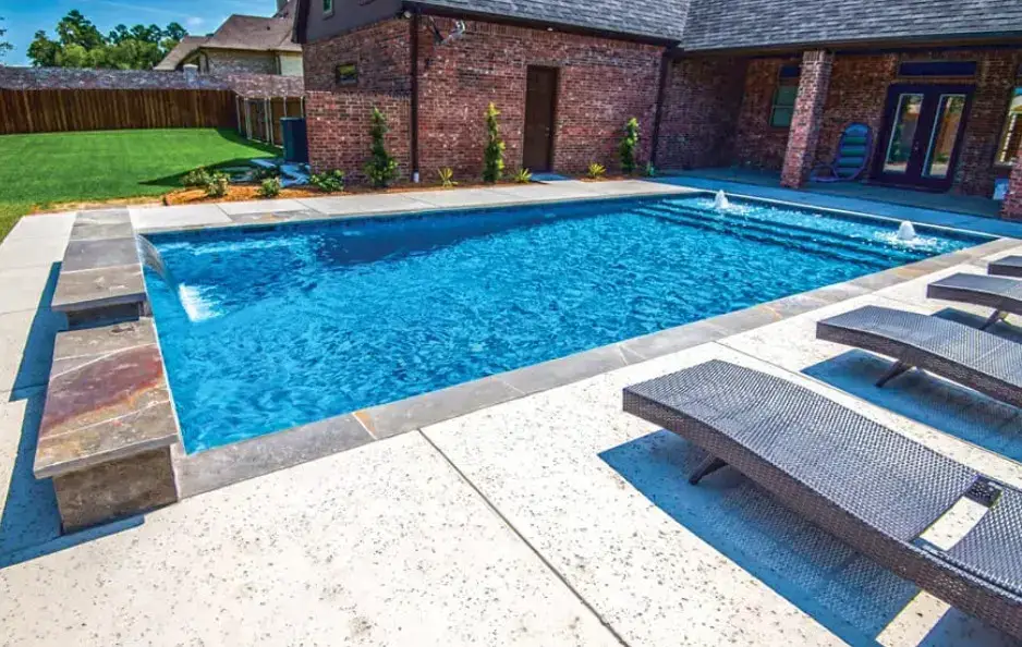Modern rectangular pool with tanning ledge, bubblers, and sheer descent